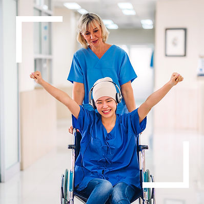 Palliative care patient in a wheelchair being supported by a healthcare professional in a compassionate setting.