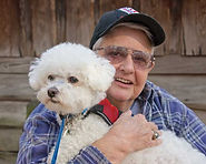 Bobby holding her service dog Brodie in her lap