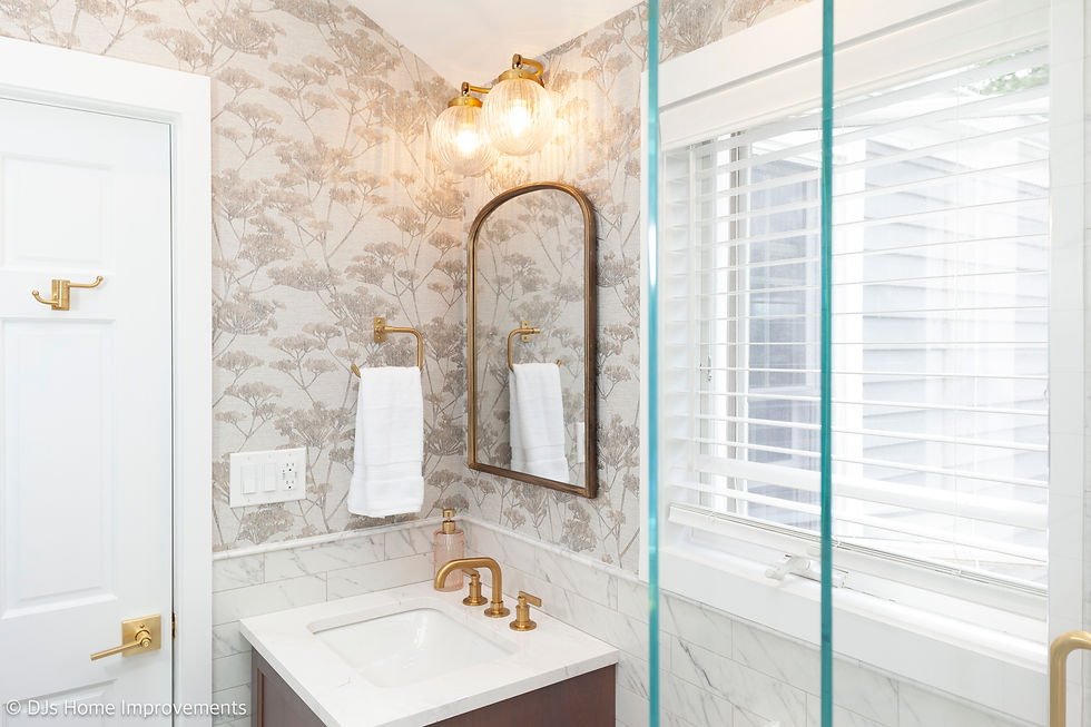 Hall bathroom vanity with wood-framed medicine cabinet, Kohler Castia™ sink faucet, and wall tile extending halfway up the room.