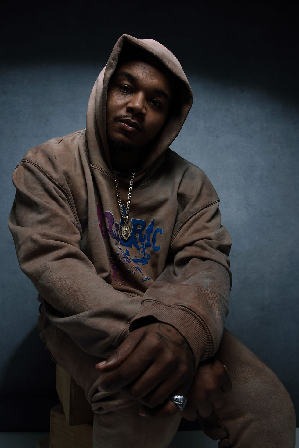 man sitting with a hoodie