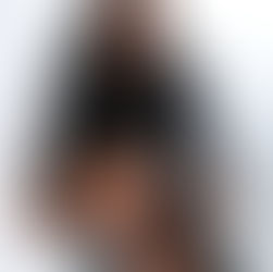 Women in all black sitting on directors chair