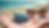 Eye-level view of sunglasses and contact lens case on a beach towel