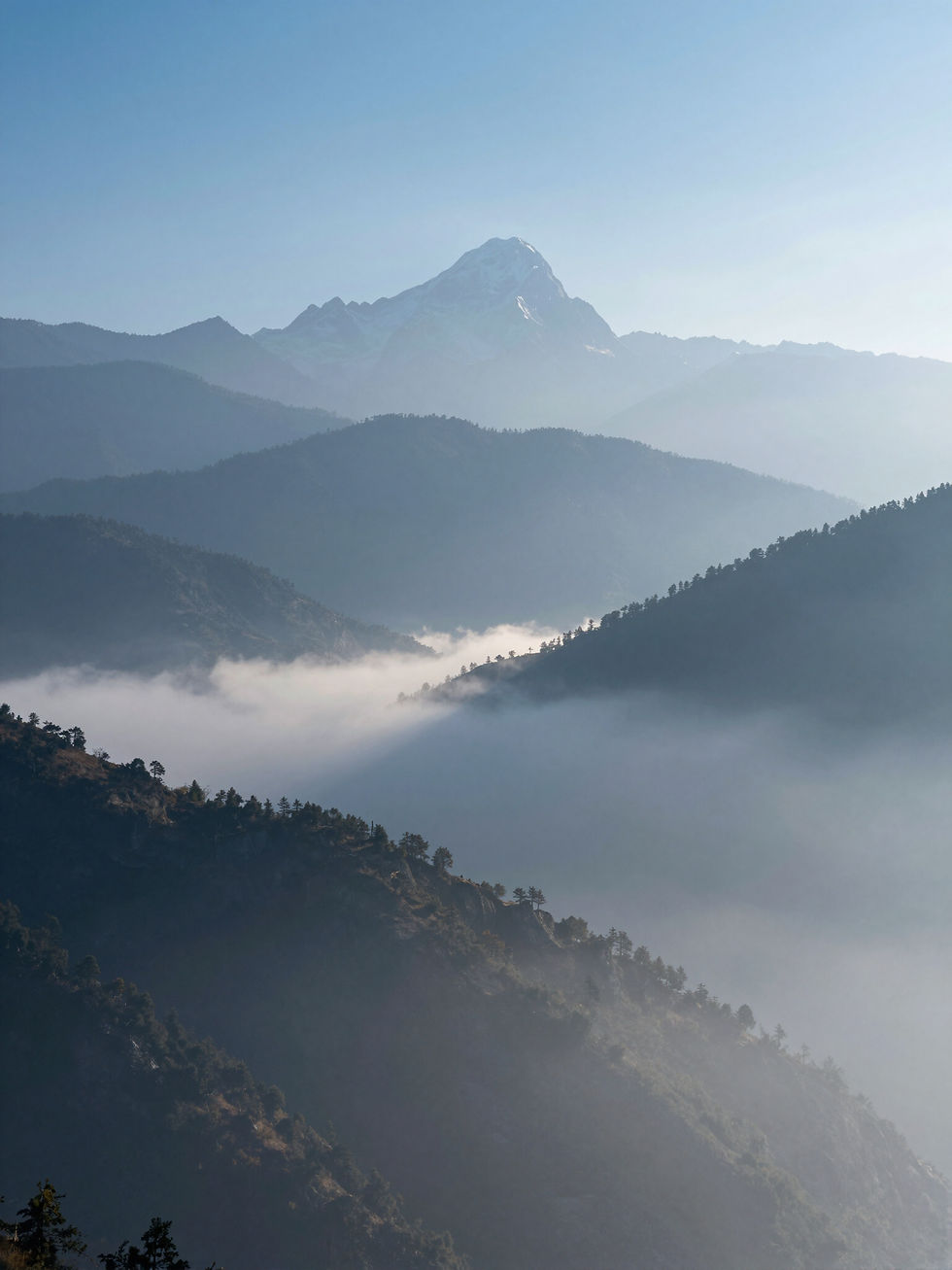 Misty mountain ranges and distant peak, Bhutan