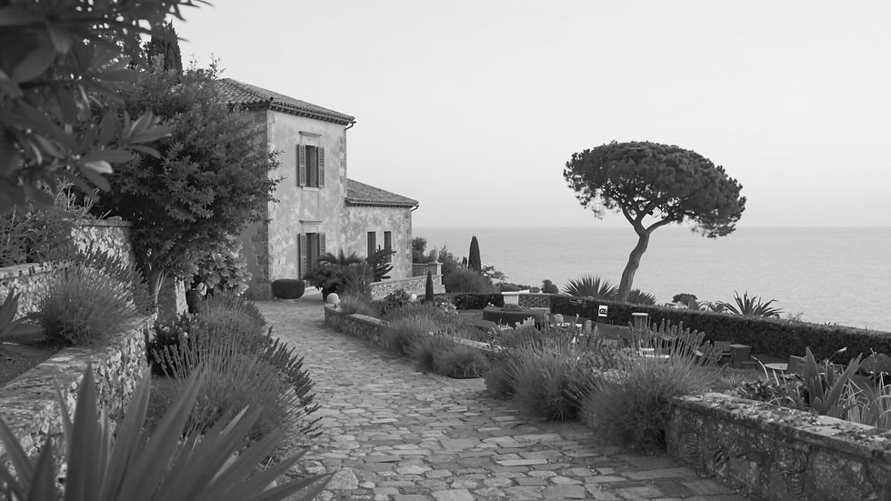 Seaside villa Europe with stone path, evoking bespoke luxury travel