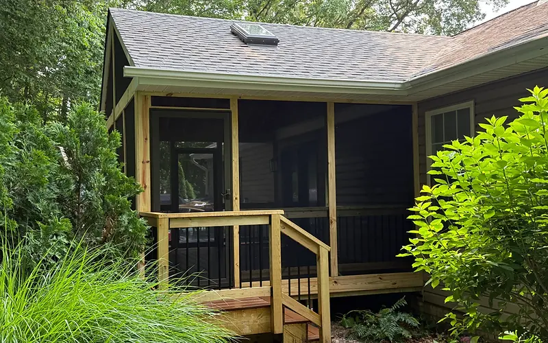 Screened-in porch addition with wood framing and steps built by PRG Home Improvement