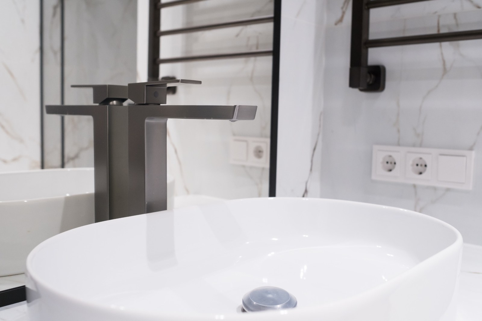 Basin with tall chrome tap
