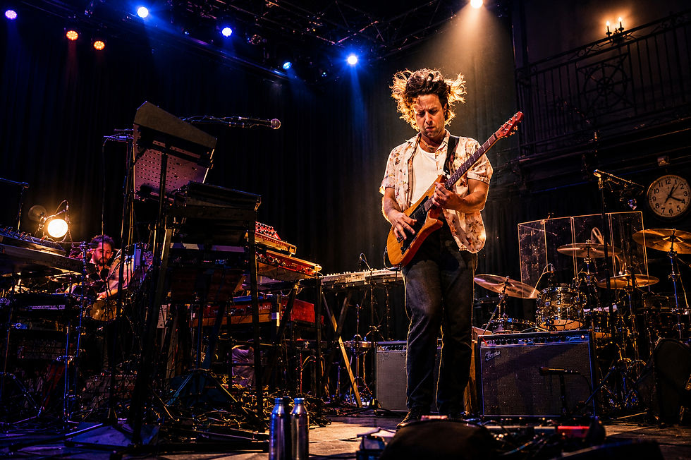 Guitarist electrifies the stage during Passion Pit's live performance at the iconic 9:30 Club.
