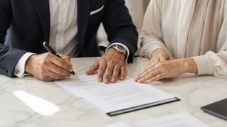 Couple signing legal documents for UAE property estate planning
