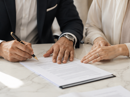 Couple signing legal documents for UAE property estate planning