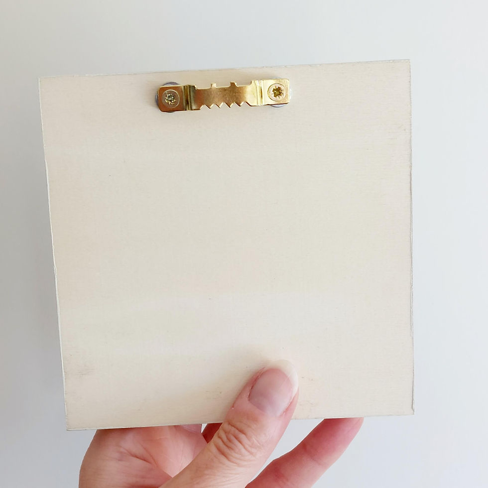 Thumbnail: A hand holding a wooden box frame, the reverse of which is shown and demonstrates saw tooth fixing used for wall hanging