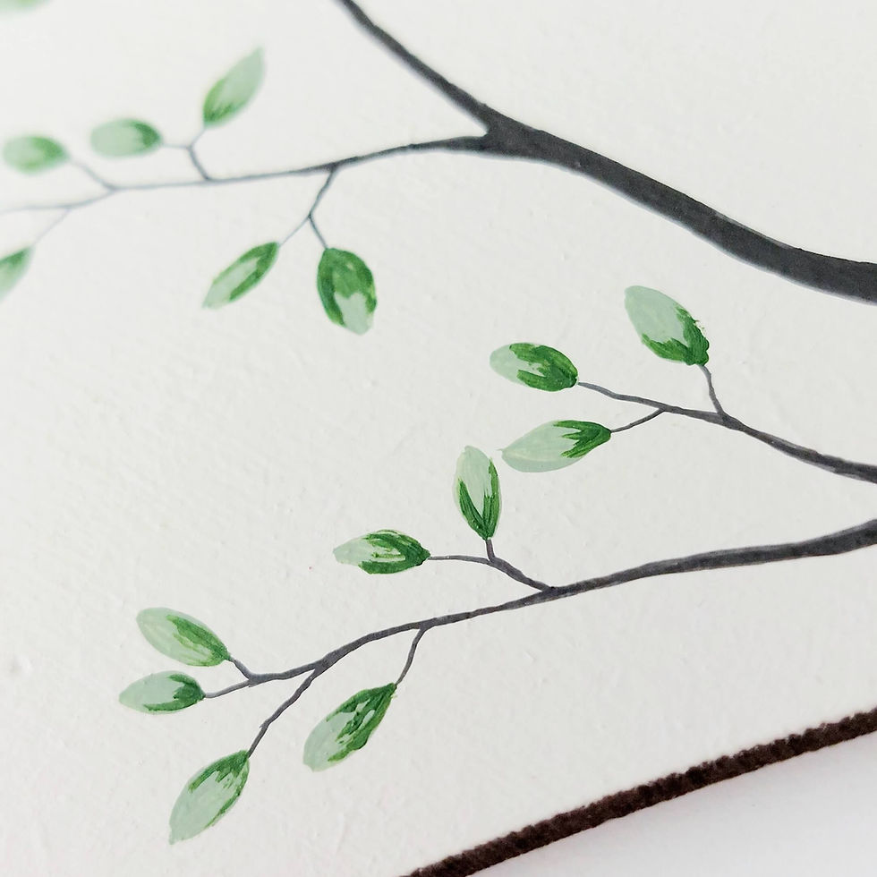 Thumbnail: A white wooden heart hanging decoration embellished with a brown sea glass robin perched on a branch.