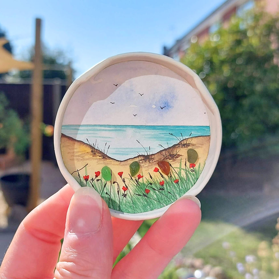 Handmade coastal fridge magnet with hand-painted beach scene, sea glass flowers and recycled red jar lid.