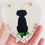 Thumbnail: A hand holding a white hand painted heart decoration showing a silhouette of a dog with green sea glass embellishments.