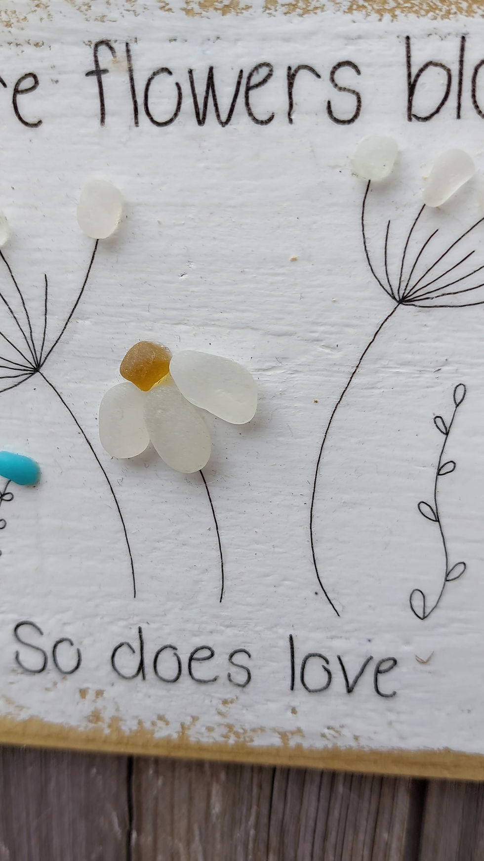 Thumbnail: Square piece of reclaimed wood, hand painted and decorated with sea glass flowers and text 'where flowers bloom so does love'