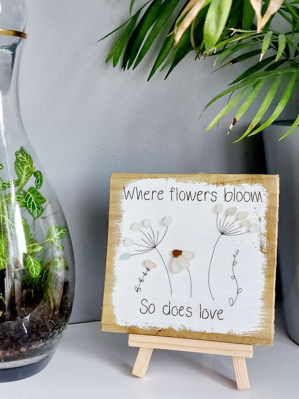 Thumbnail: Square piece of reclaimed wood, hand painted and decorated with sea glass flowers and text 'where flowers bloom so does love'