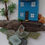 Thumbnail: A piece of square wall art in a white box frame, decorated with driftwood and sea glass to make a coastal cottage scene.