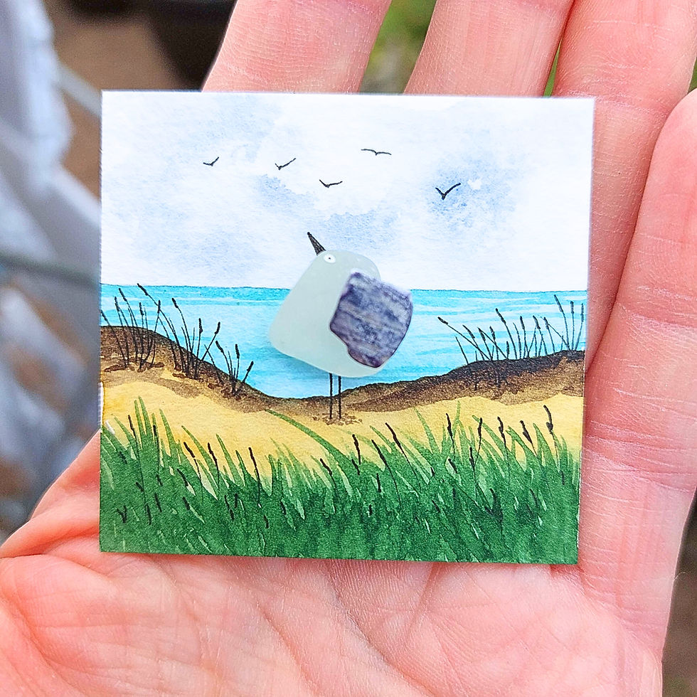 Thumbnail: Handmade sea glass seagull artwork on a miniature coastal scene with sandy dunes, ocean view and flying birds.