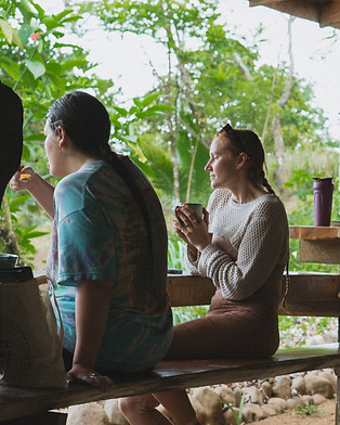 Guests enjoying coffee and conversation at Protopia’s permaculture community in Costa Rica during a short-term visit.