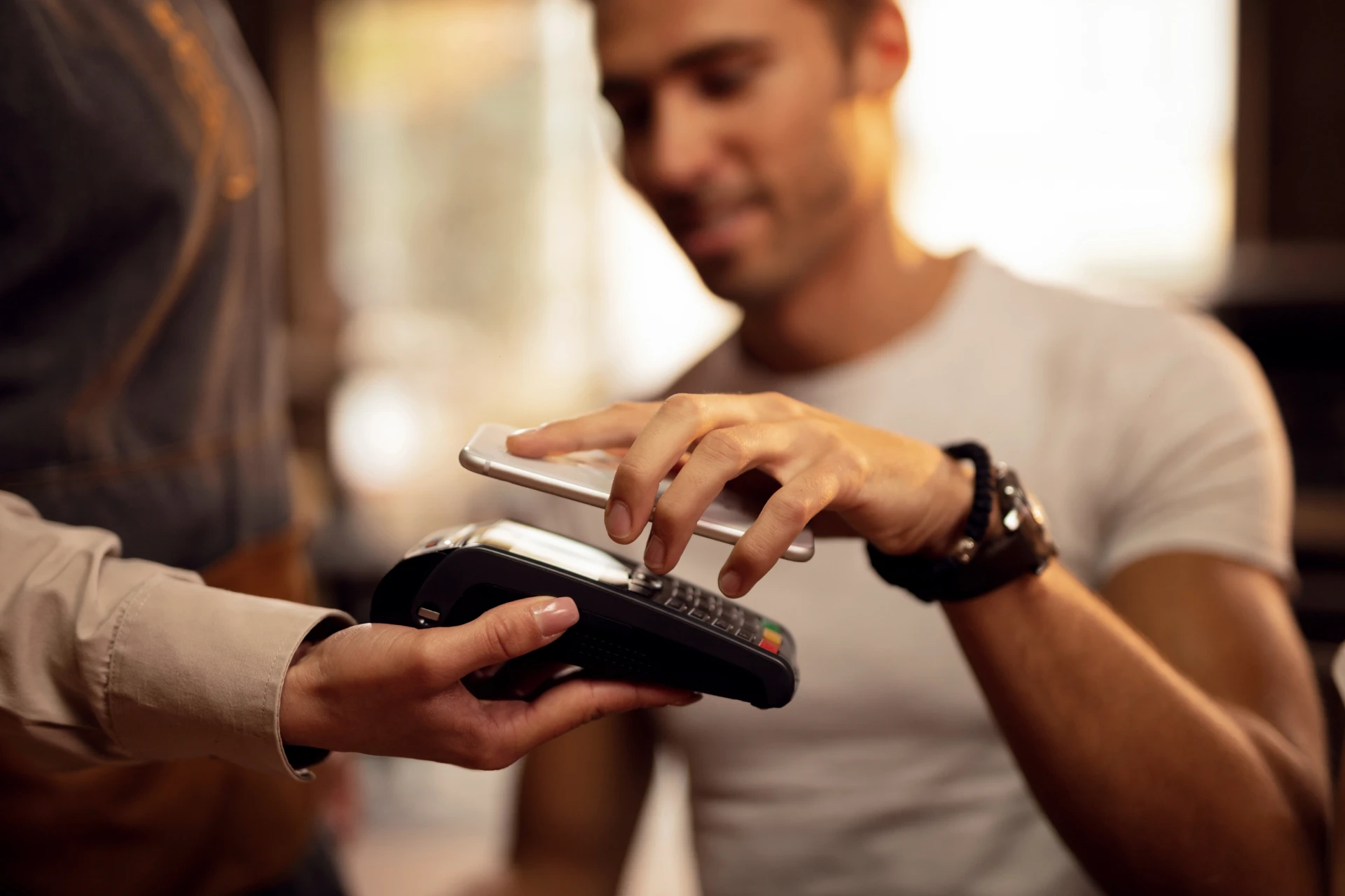 close-up-guest-using-smart-phone-while-making-contactless-payment-pub (1).webp