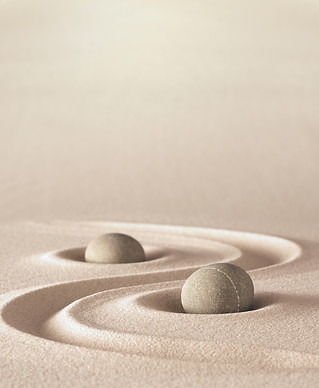 zen garden meditation stone background with copy space stones and lines in sand for relaxa