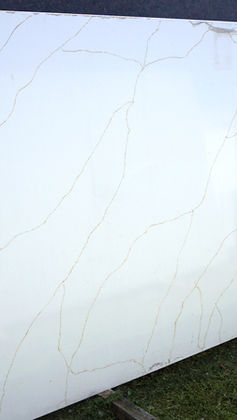 Sienna Gold quartz slab featuring a clean white background with delicate, warm golden veining that flows organically across the surface for a subtle and elegant look.