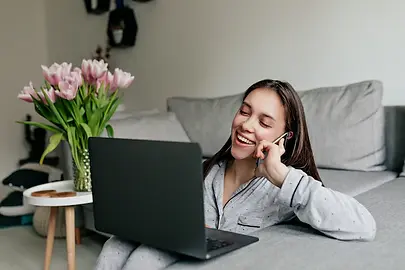 happy-smiling-woman-pajamas-talking-phone-working-with-laptop-modern-stylish-apartment-qua