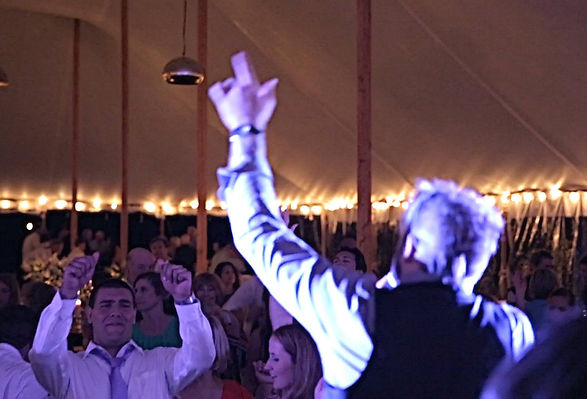 Crowd celebrating on a brightly lit dance floor