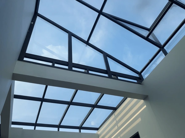 Modern glass skylight with a black metal frame