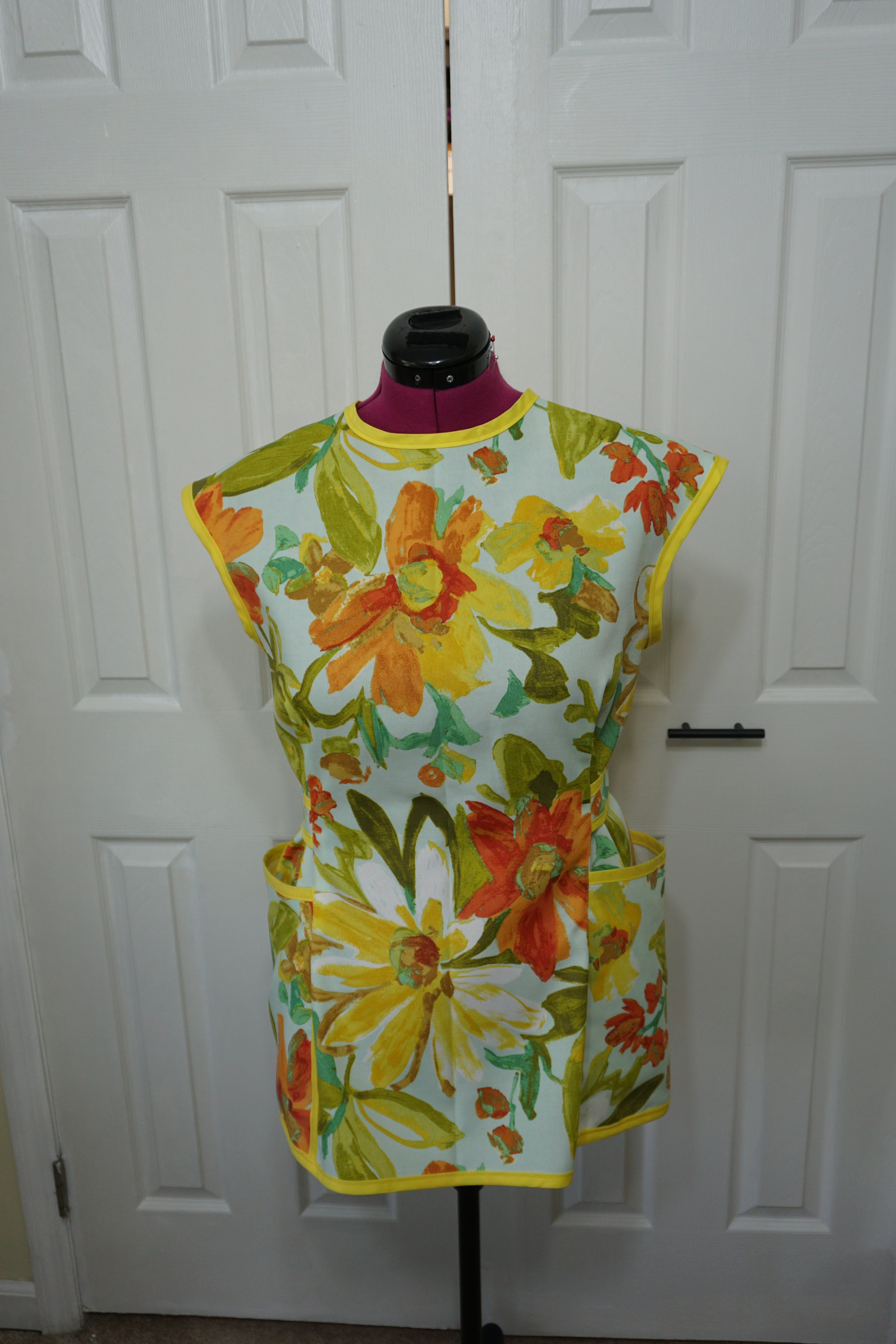 Front view of the yellow and orange flowers on a light green background.