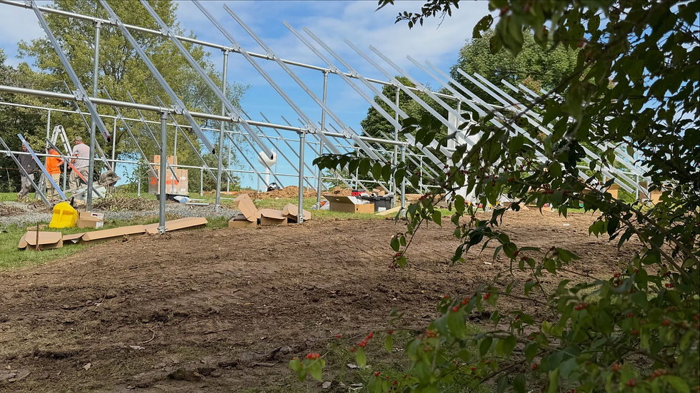 Heavy-duty galvanized steel ground-mount solar racking structure under construction for the IKC President before the solar panels are mounted.