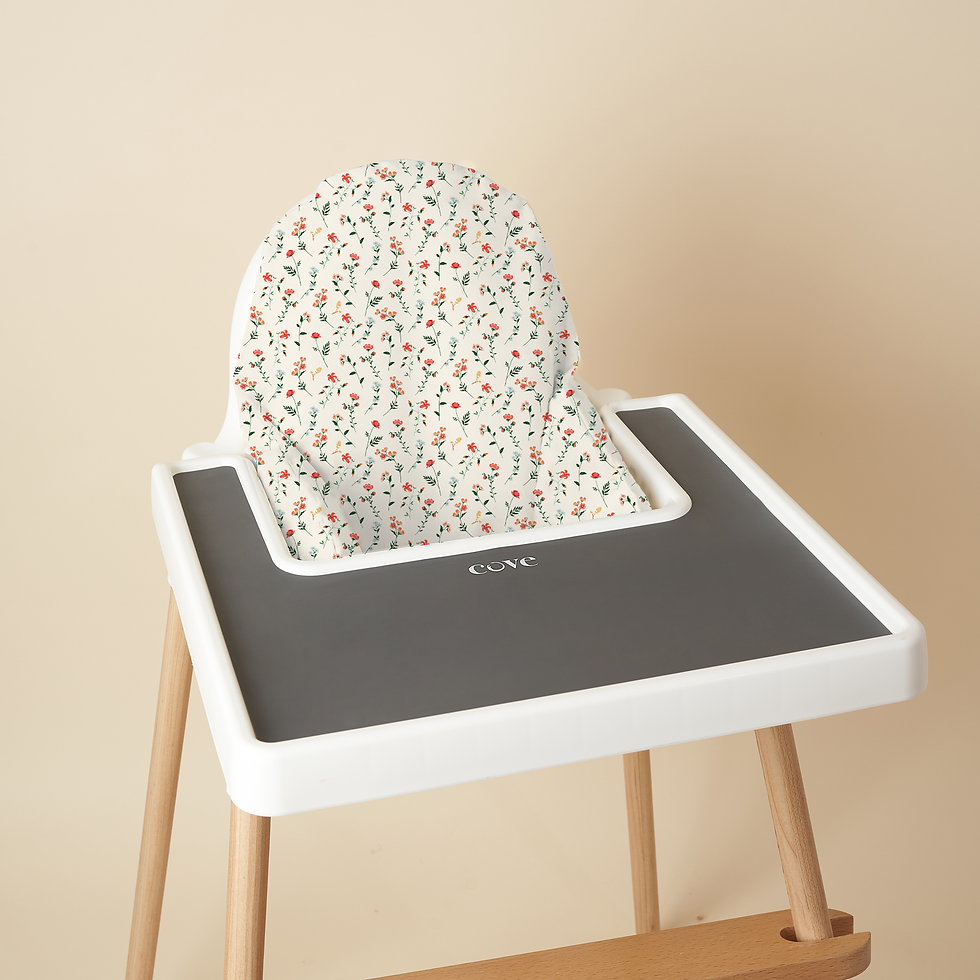 Thumbnail: A high chair with a floral cushion that features red flowers and green leaves. The tray has a black silicone place mat