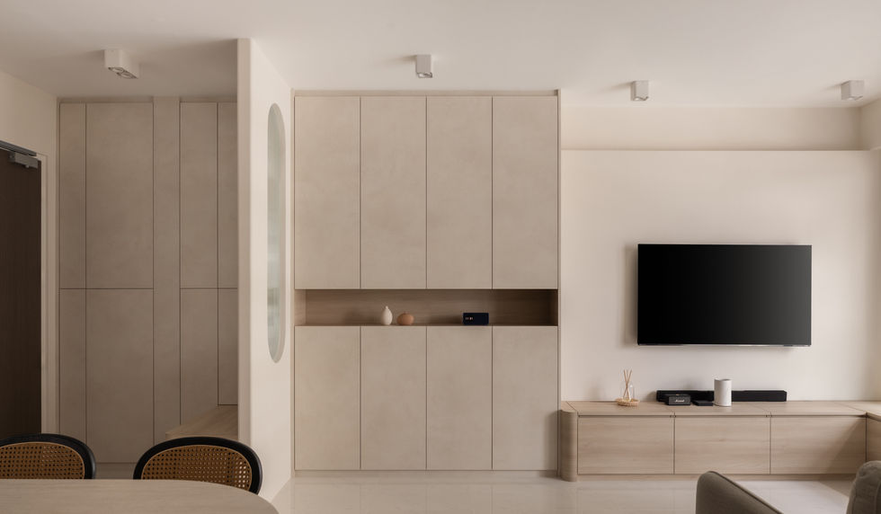 Full-height built-in shoe cabinet with hidden storage in minimalist living room.