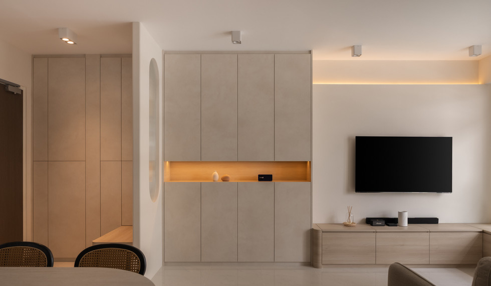 Full-height built-in shoe cabinet with hidden storage in minimalist living room.