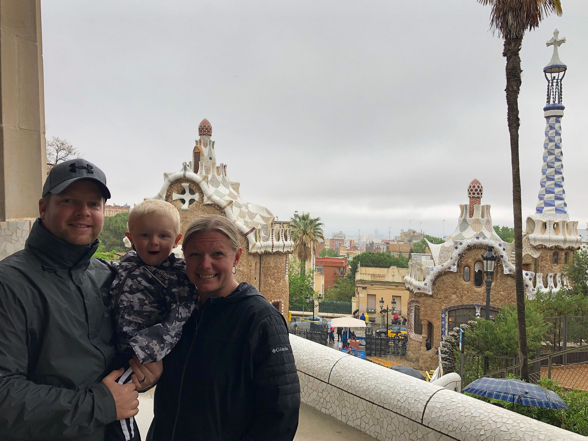 Family photo standing with Park Guell in the background.