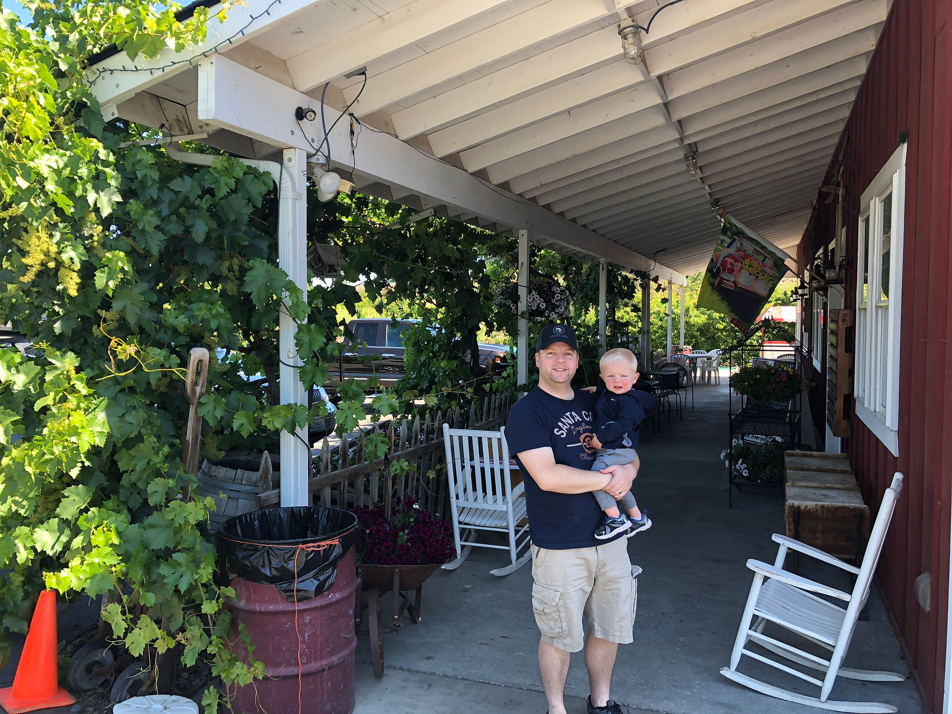 Father and son standing near the read barn at Barrett Orchards in Yakima.