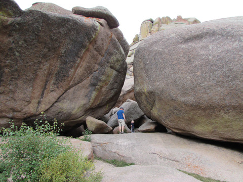 Father and son climbing thru the huge rocks at Vedauwoo Recreation Area
