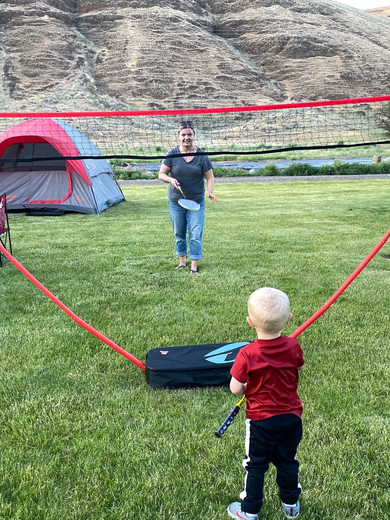 Mother and son playing badminton. 