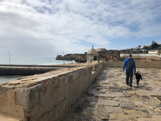 Father and small child walking along the rootop of Forte de Ponta da Bandeira in Lagos.