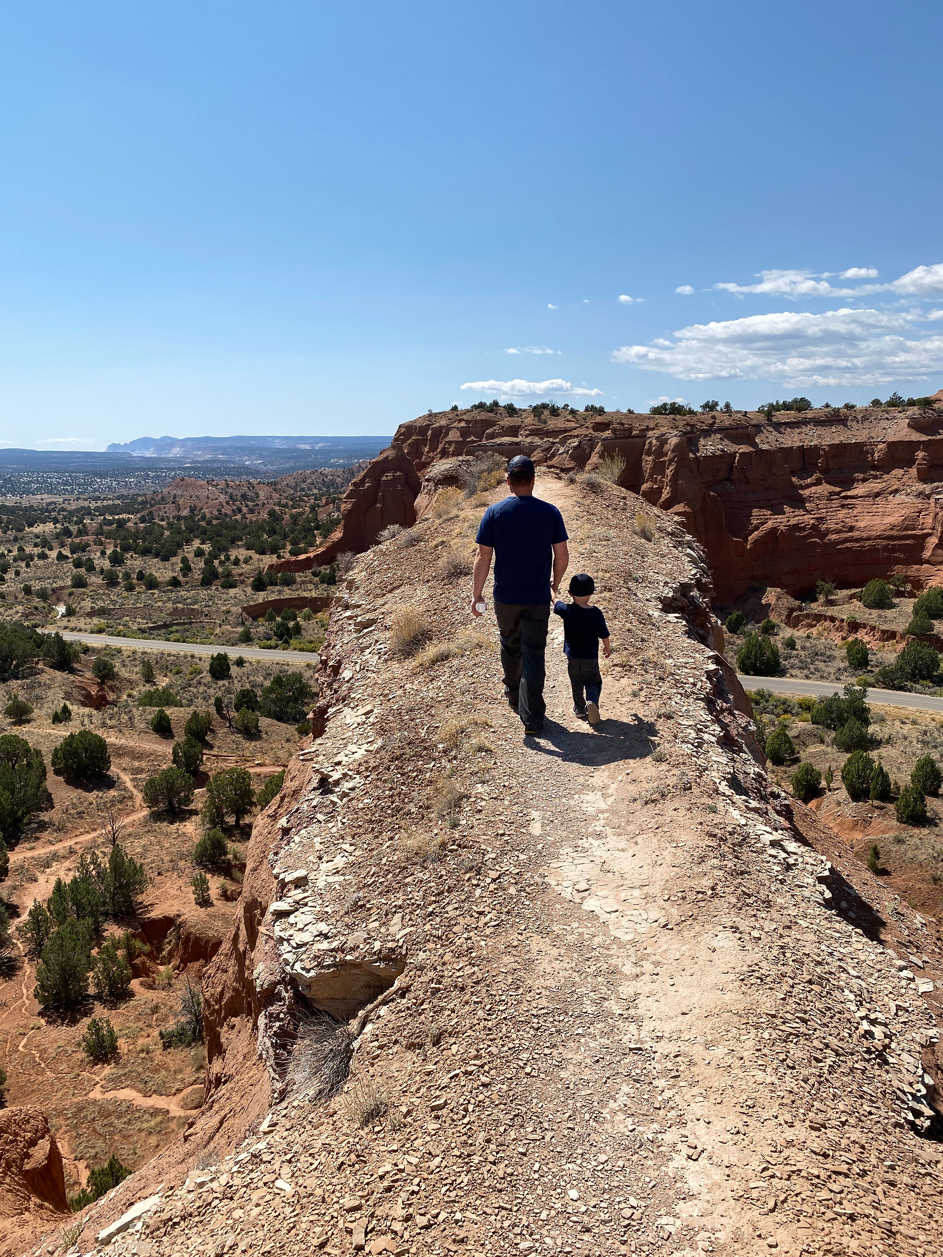 Father and son walk along the narrow trail that overlooks the Kodachrome Basin.