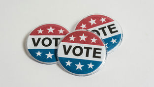 Three pins with vote text and red, white & blue star imagery