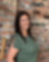 Lindemann Creative Services owner leans against brick wall
