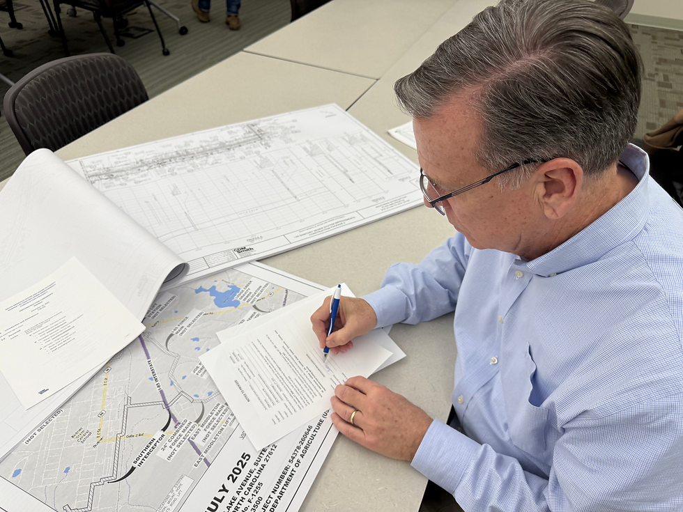 SGWASA Executive Director Scott N Schroyer reviews the updated I-85 SSI Project CP2 Construction Zone Map after signing the construction Notice to Proceed