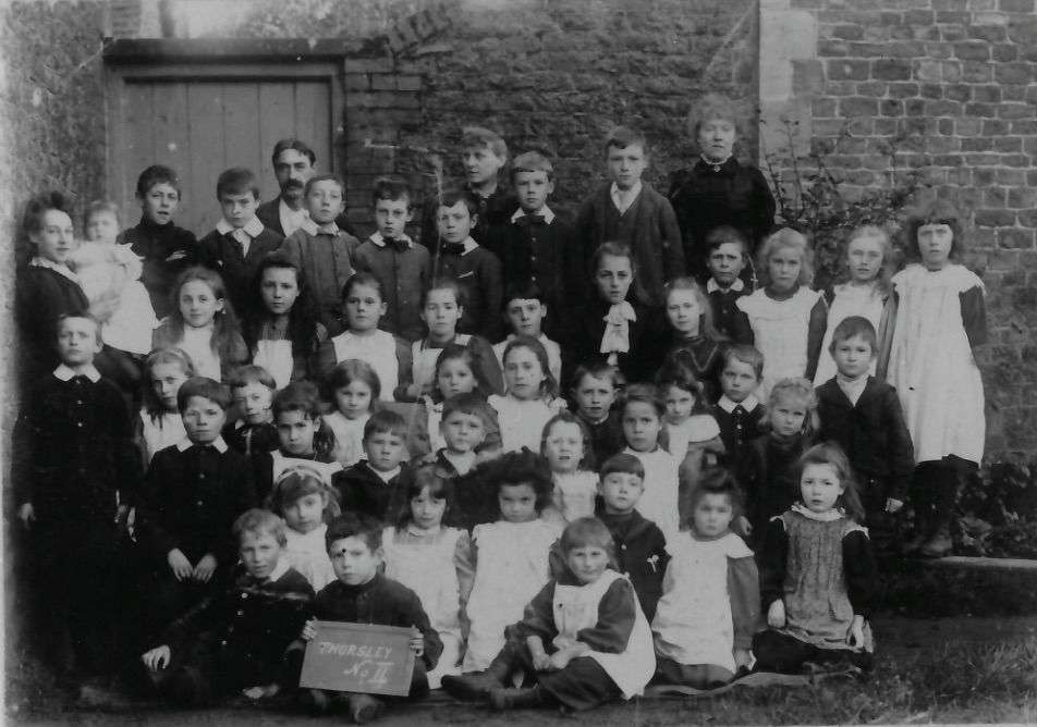 Thursley School c 1900. Annie Cunningham of Bowlhead Green is 2nd row from back and 5th from right in braided dress.