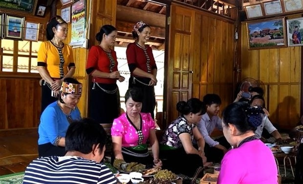 Tourists experience the culinary culture of the Thai ethnic group in Con Cuong district (Nghe An province). (Photo: Van Ty/VNA)