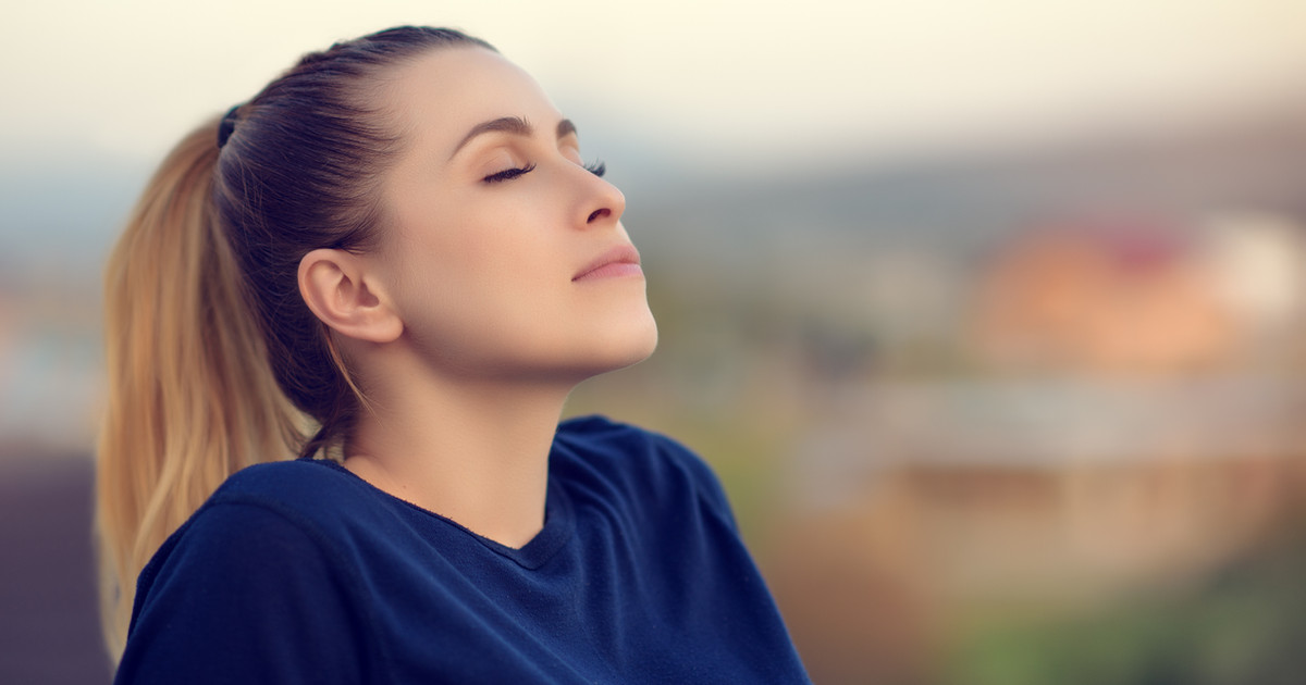 A person practising diaphragmatic breathing in a quiet, comfortable space to promote relaxation and support better sleep.