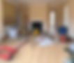 building company arriving onsite with tools and equipment laid across the floor of a house