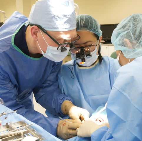 Dentists working on implant for patient