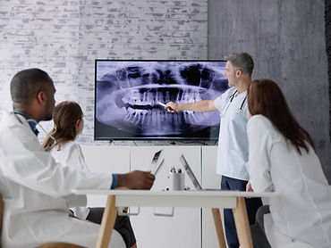 Dentists looking at dental x-ray