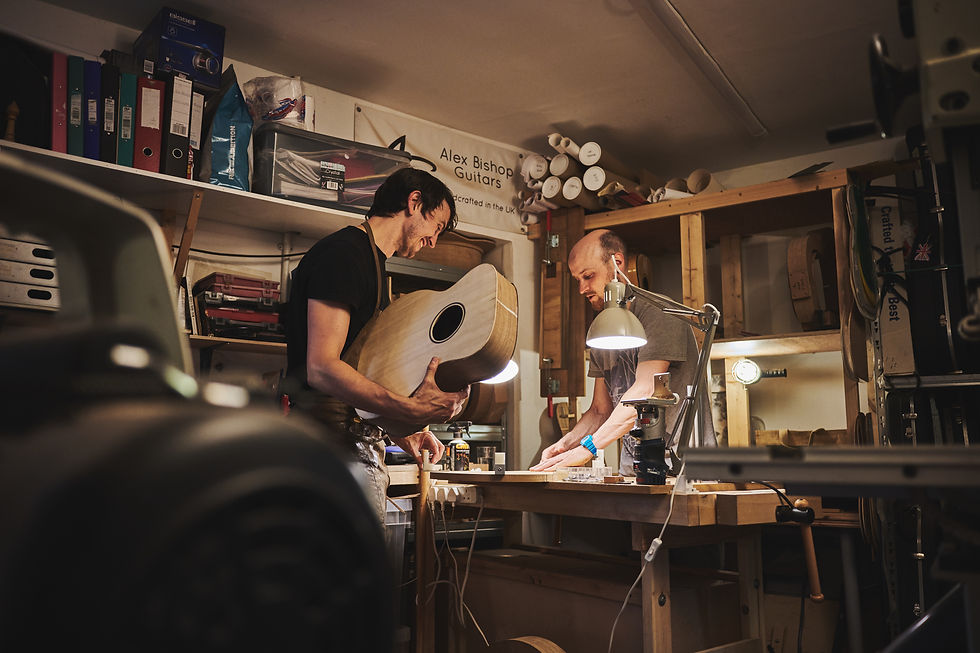 Guitar maker Alex Bishop helps lutherie student build a guitar.