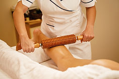unrecognizable-therapist-performing-maderotherapy-woman-s-legs-during-massage-treatment-sp